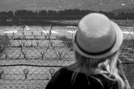 Unrecognizable woman standing against airfield