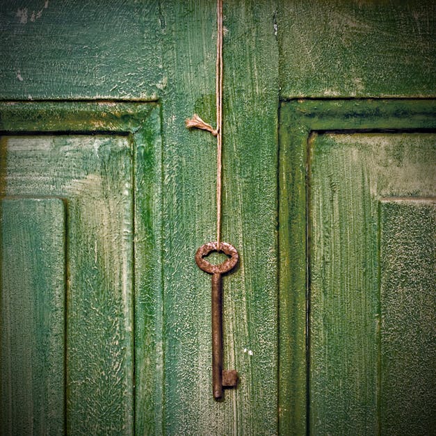 Old key hanging on wooden door · Free Stock Photo