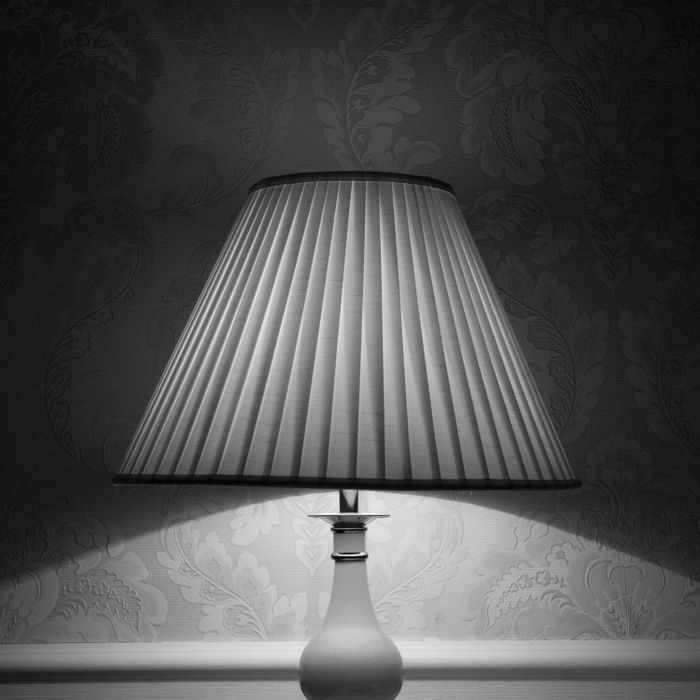 Pleated shade table lamp on a ceramic base — photo by Alexander Grigorian on Pexels