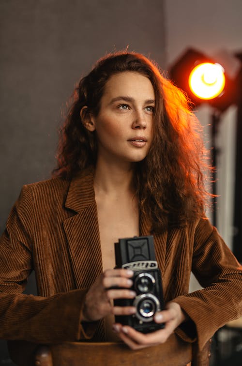 Woman in Brown Blazer Holding Black Camera