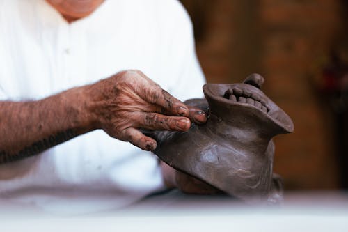 A Person Molding a Clay Mask
