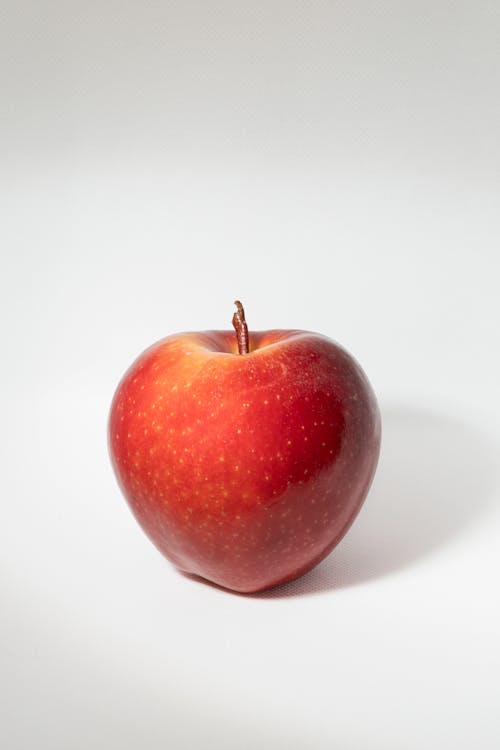 Free A Red Apple over a White Surface Stock Photo