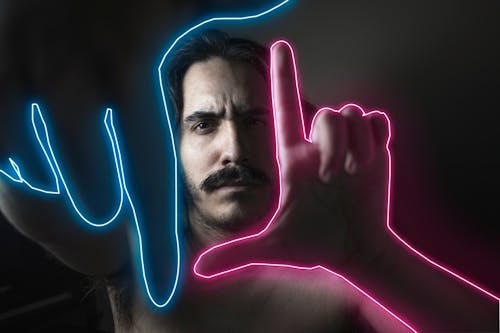 Man Gesturing with his Neon Outlined Hands