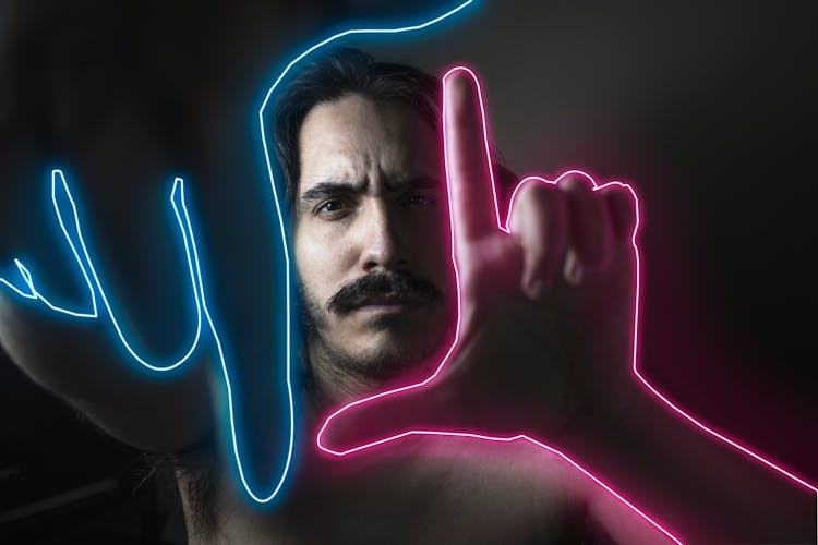 Man Gesturing With His Neon Outlined Hands