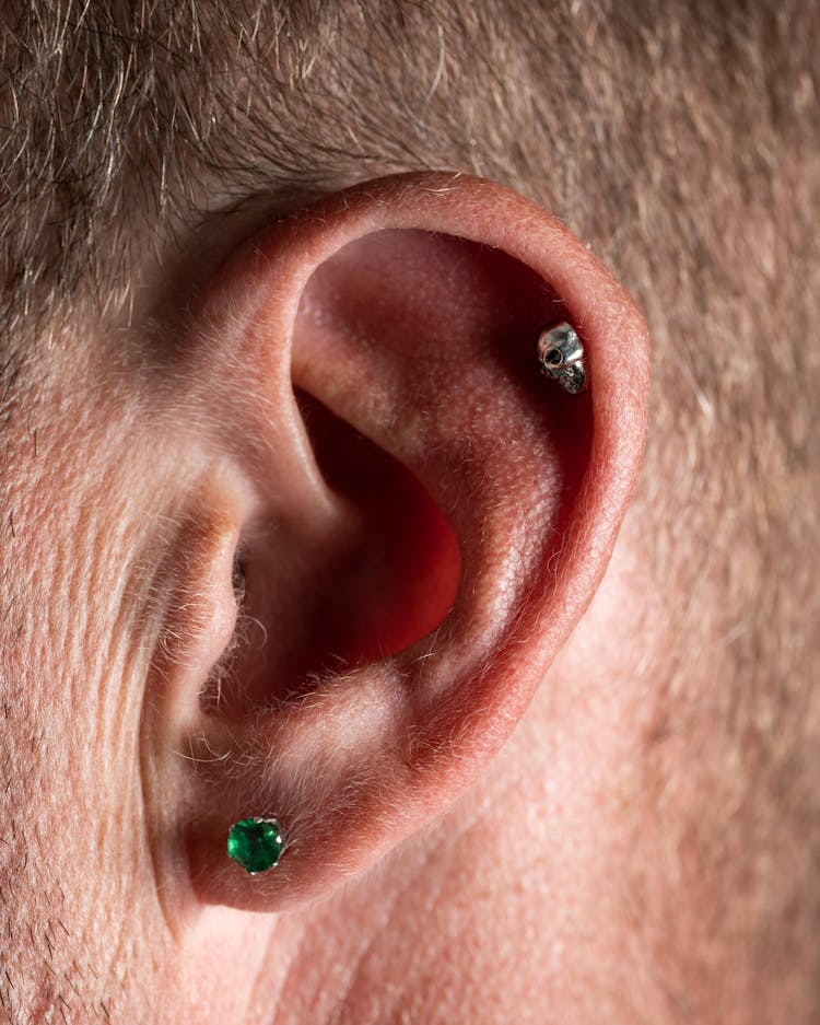 A Person With Ear Piercings 