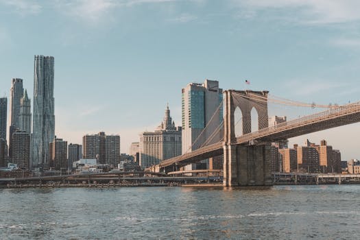 Stunning view of Brooklyn Bridge and Manhattan skyline over East River.