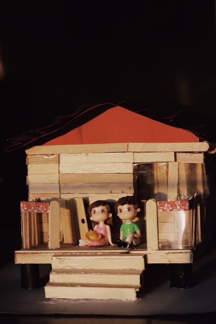 Couple Figurines On Toy House