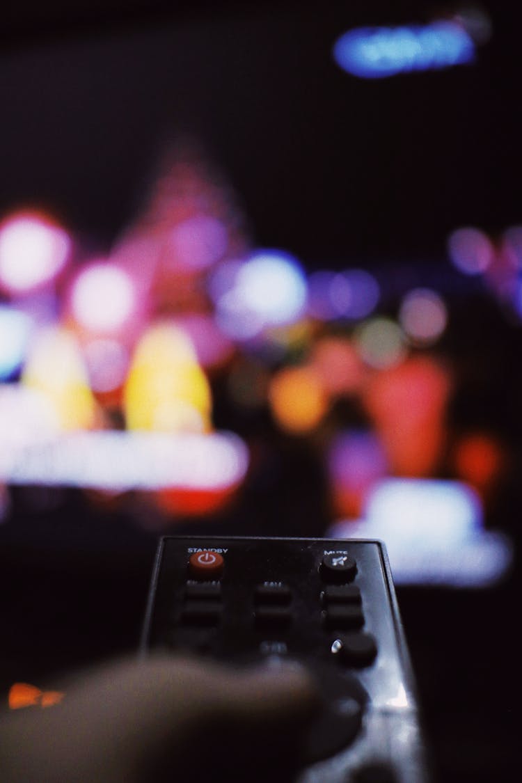 Unrecognizable Person With Remote Controller Watching TV