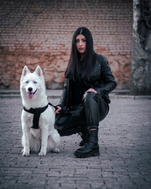 Free Woman in Black Leather Jacket and Husky Dog  Stock Photo