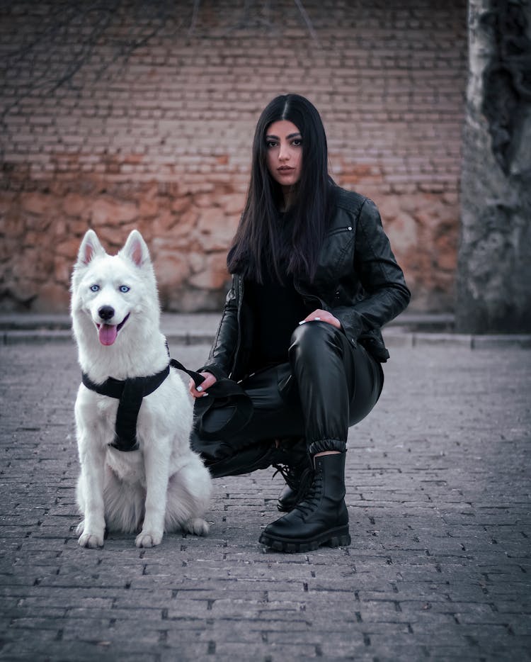 Woman In Black Leather Jacket And Husky Dog 