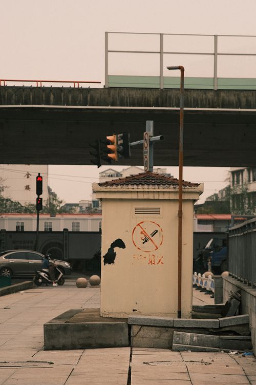 Free City street view with a utility box and overpass, capturing the urban atmosphere. Stock Photo