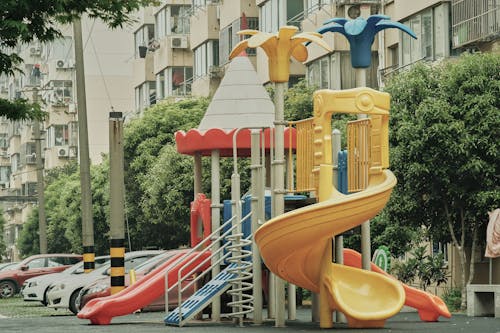 Playground Slides Near Buildings and Trees