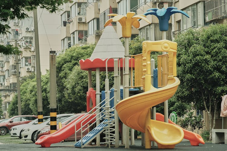 Playground Slides Near Buildings And Trees