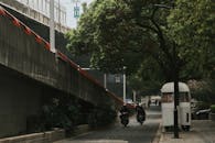 Men Driving Scooters in the City