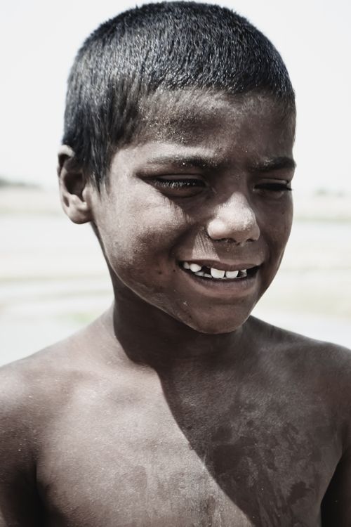 Free Close-up portrait of a joyful boy smiling outdoors. Stock Photo