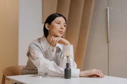 A Woman Sitting Behind a Table