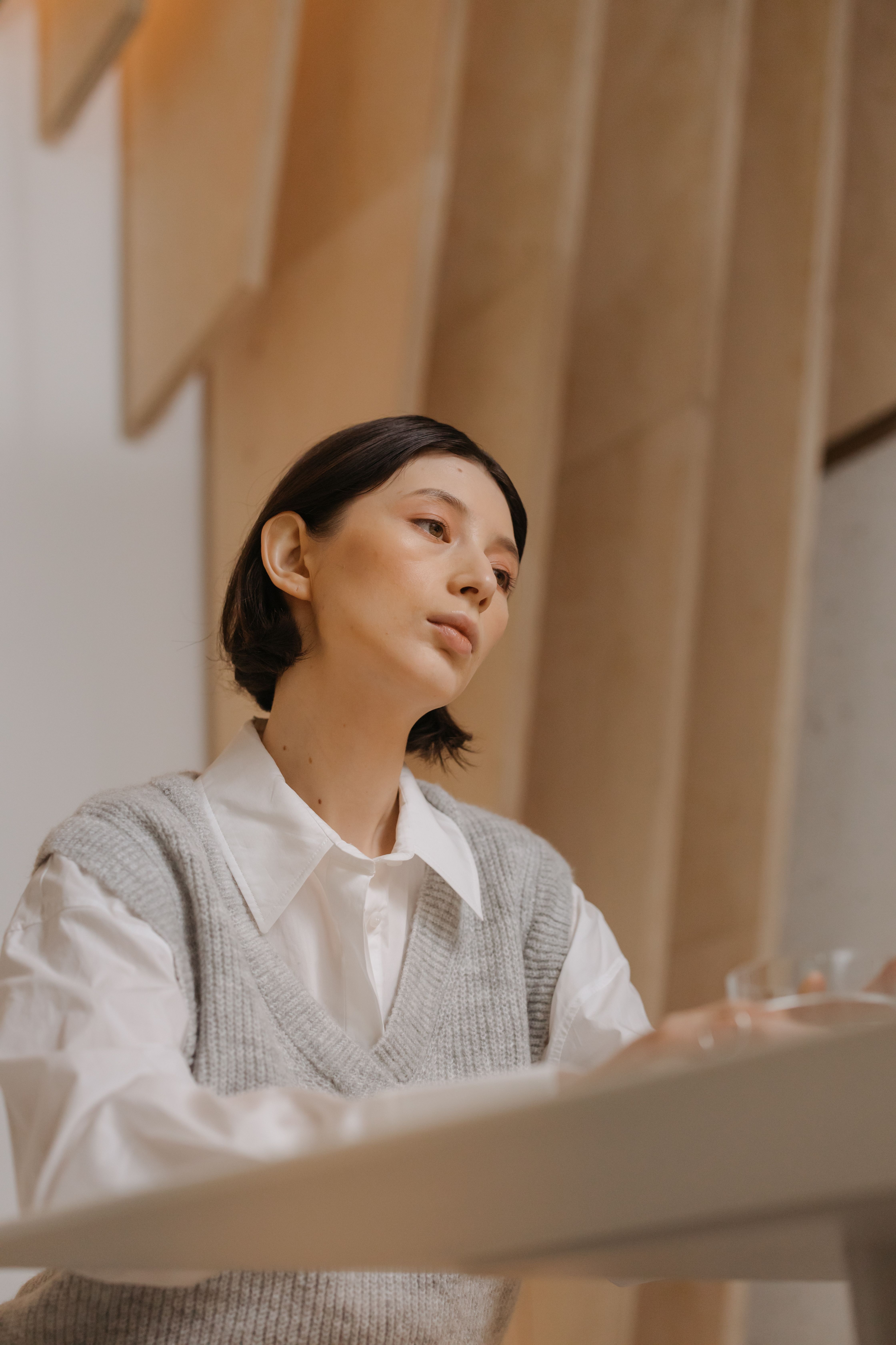 Woman in White Long Sleeve Shirt and Gray Vest · Free Stock Photo