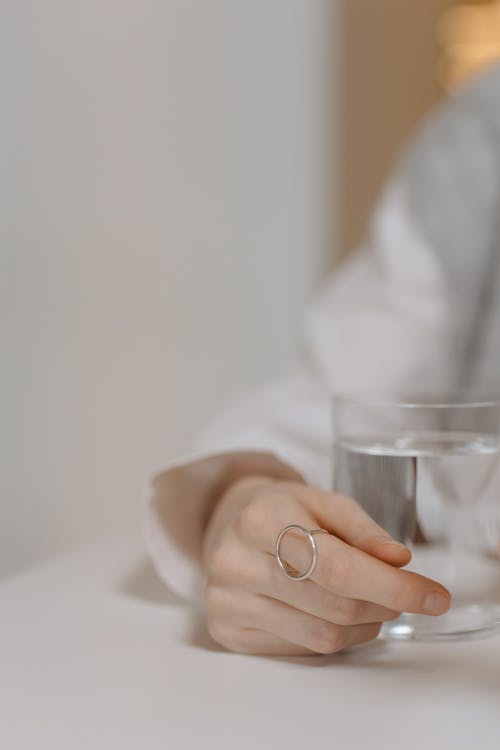 Free Close-Up Shot of a Person Holding a Glass of Water Stock Photo