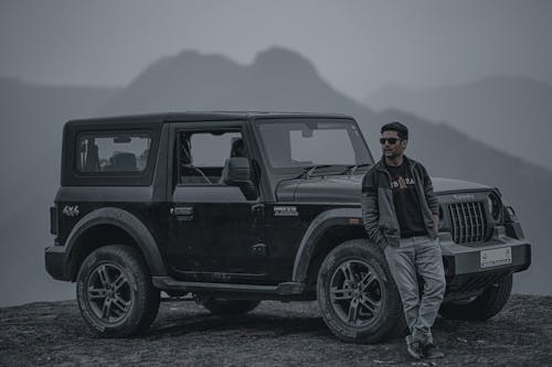 A Ma Standing in Front of a 4x4 Off Road Vehicle