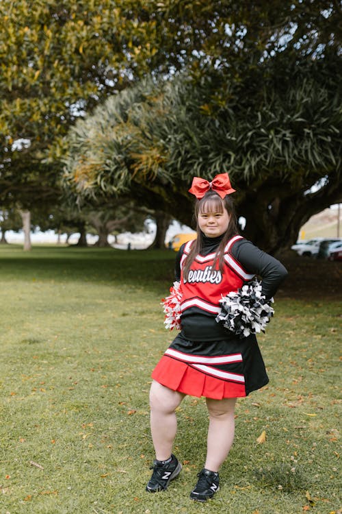A Woman in Cheerleader Outfit Standing