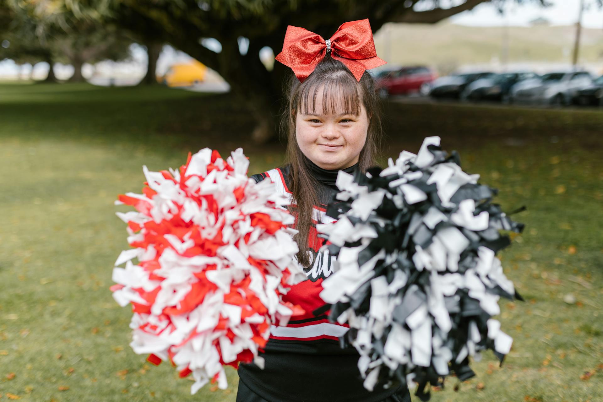 Woman in Cheerleader Outfit Holding Pompoms