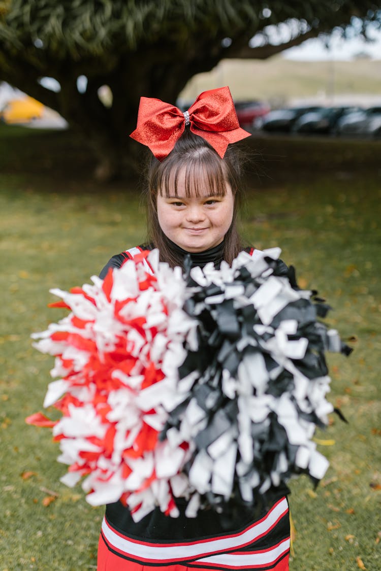 Woman In Cheerleader Outfit Holding Pompoms