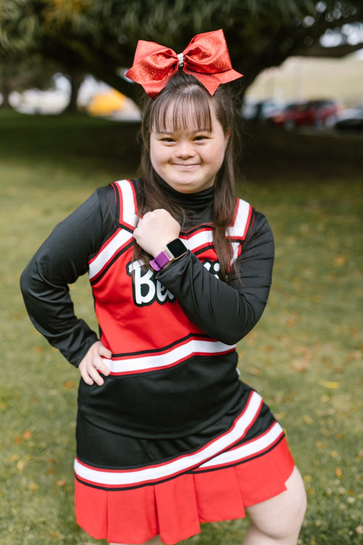 A Woman In Cheerleader Outfit Showing Her Watch