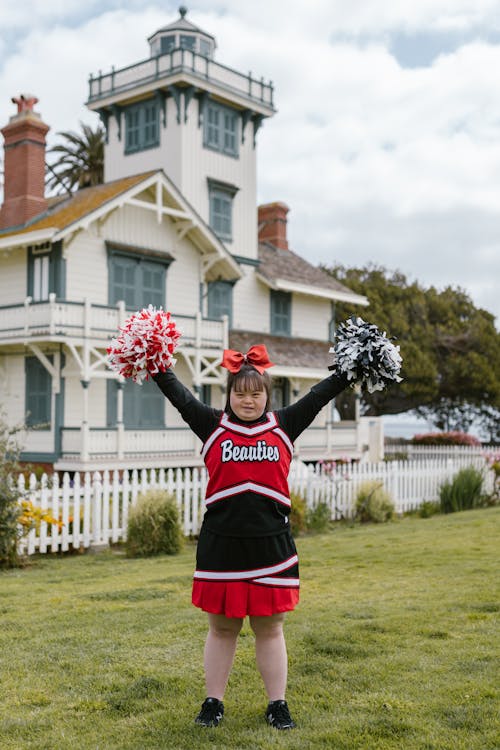 A Woman in Cheerleader Outfit Standing Outside