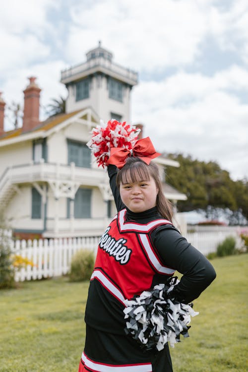 A Woman in Cheerleader Outfit Holding Pompoms