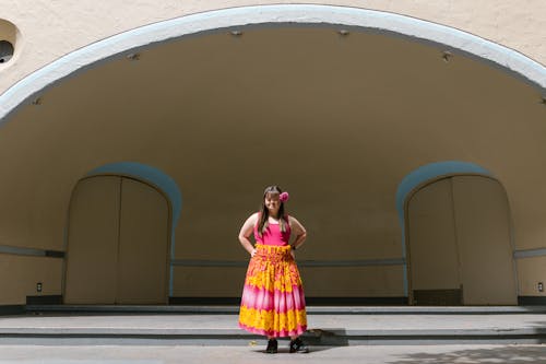 A Girl in a Floral Skirt Standing on a Stage