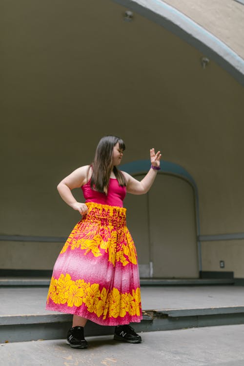 A Girl in Floral Skirt Posing on a Stage