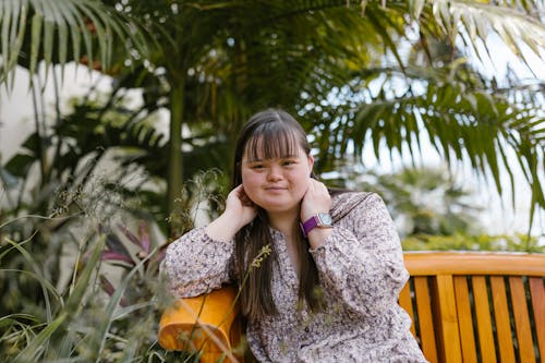 A Girl with a Floral Top Sitting on a Bench