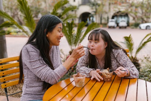 Mother Feeding Her Daughter Ice Cream