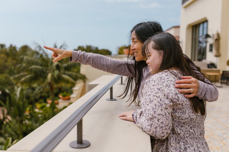 A Mother Pointing Her Finger While Spending Time With Her Daughter