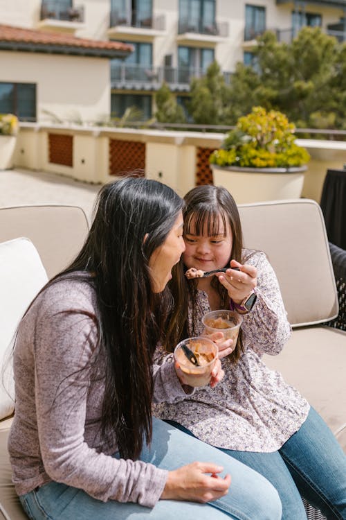 A Girl Feeding Pudding to Her Mother