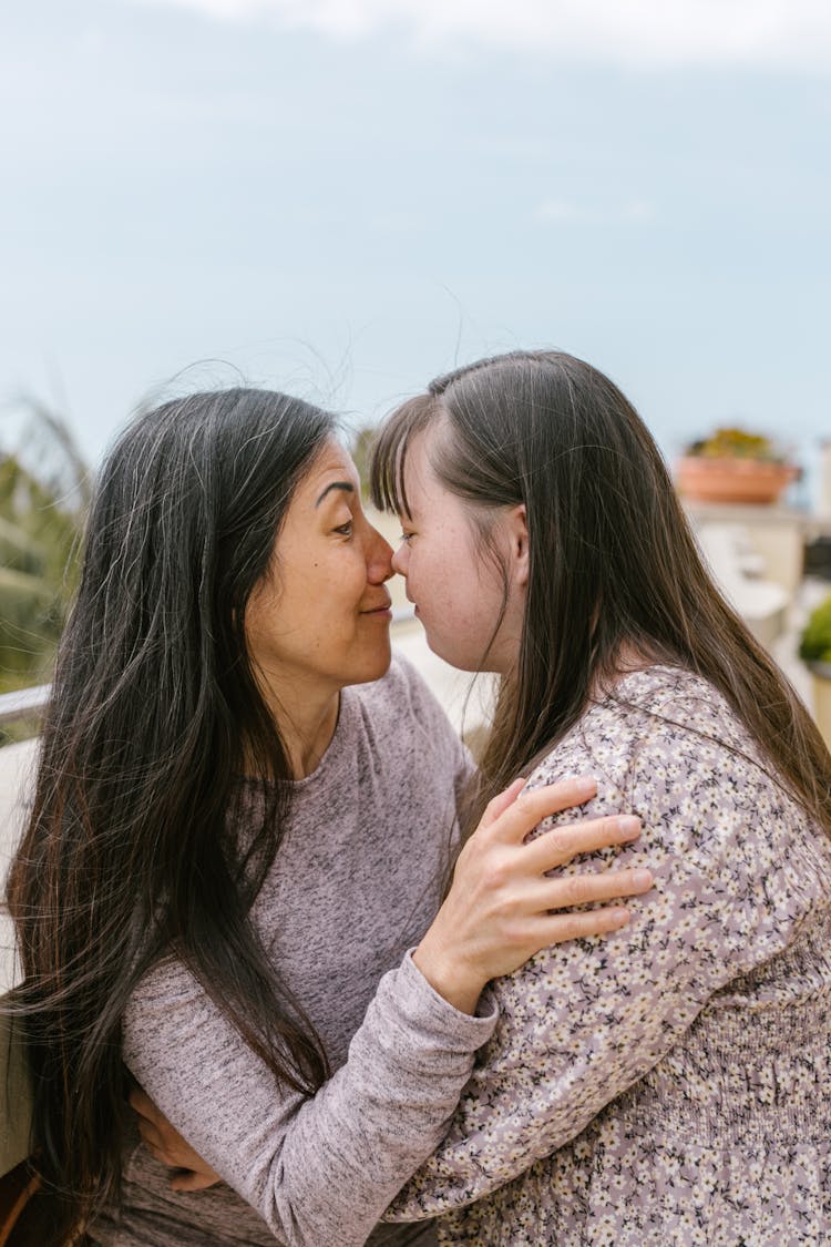 Mother And Daughter Touching Noses