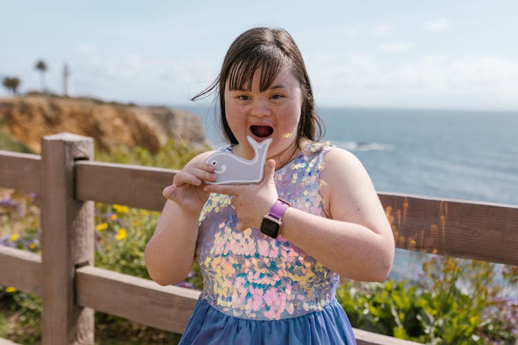 A Girl Holding A Whale Shaped Cookie