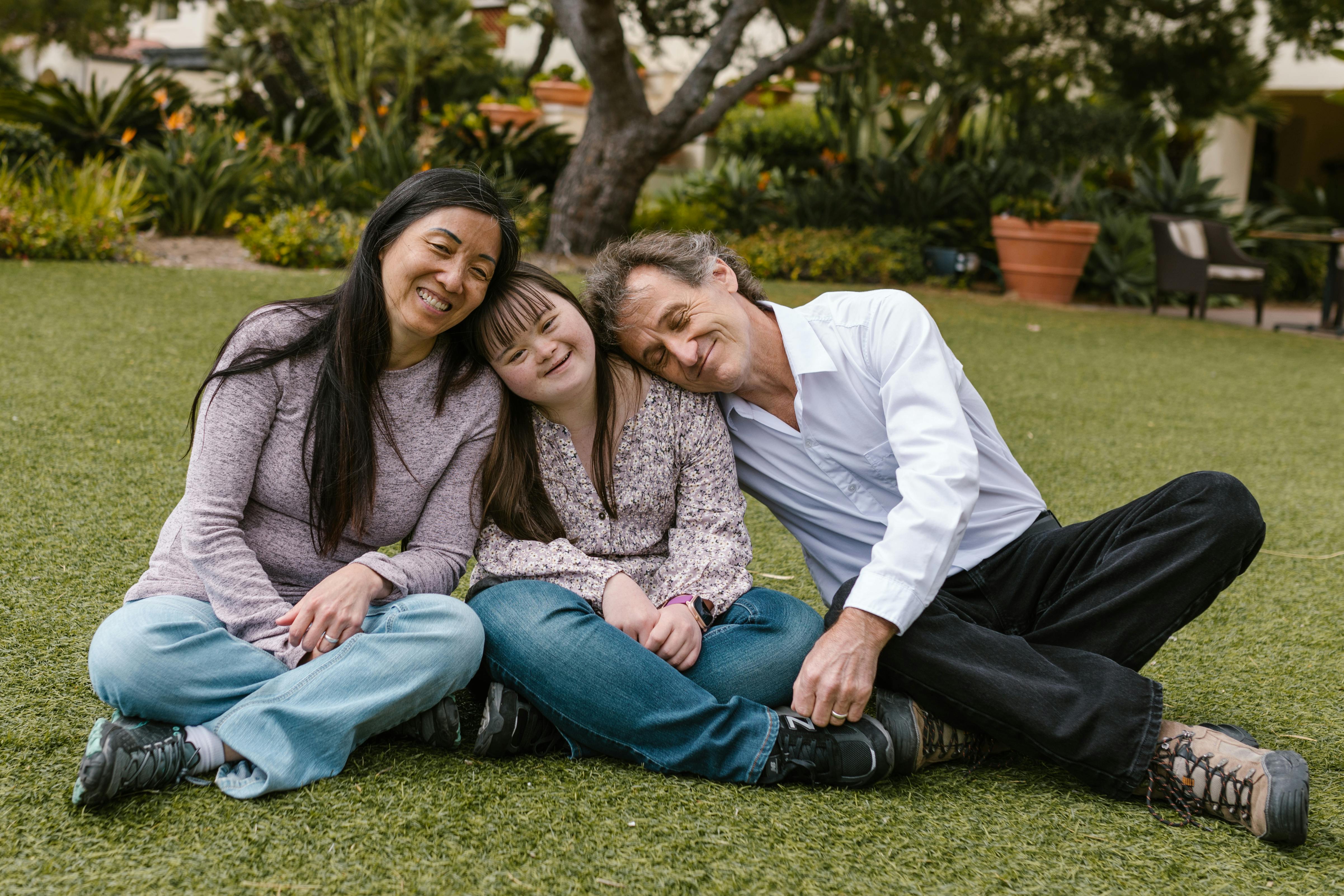 a happy family sitting on the grass