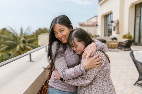 A Mother Hugging Her Daughter