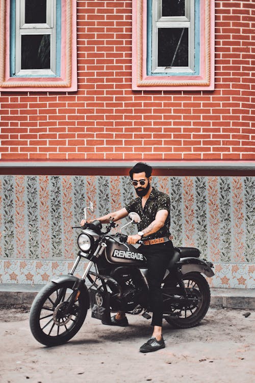Free A Bearded Man Riding a Motorcycle Stock Photo