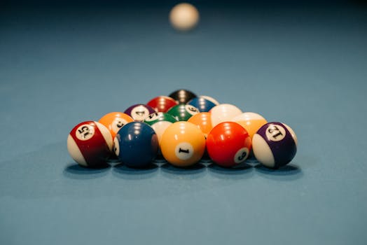 Close-up view of colorful billiard balls arranged for a pool game. Depth of field emphasizes the arrangement.