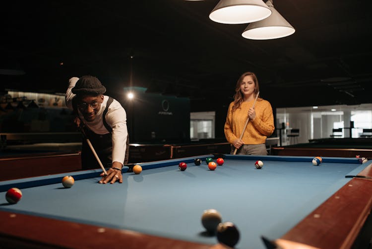 Friends Playing A Game Of Billiards