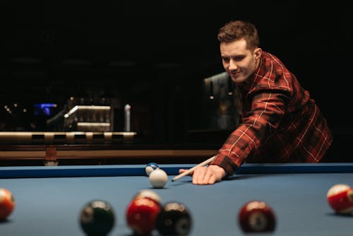 A Man Playing a Game of Billiards 