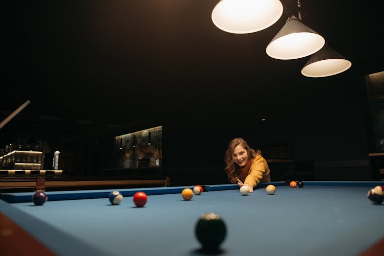 A Woman Having Fun Playing Billiards