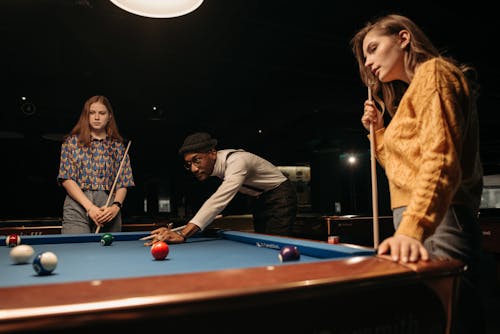 Friends Playing Billiards Together 