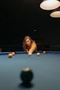 Woman in Brown Long Sleeve Shirt Playing Billiard