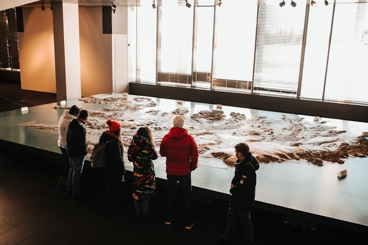 Teenagers In Museum Near Iceland Map