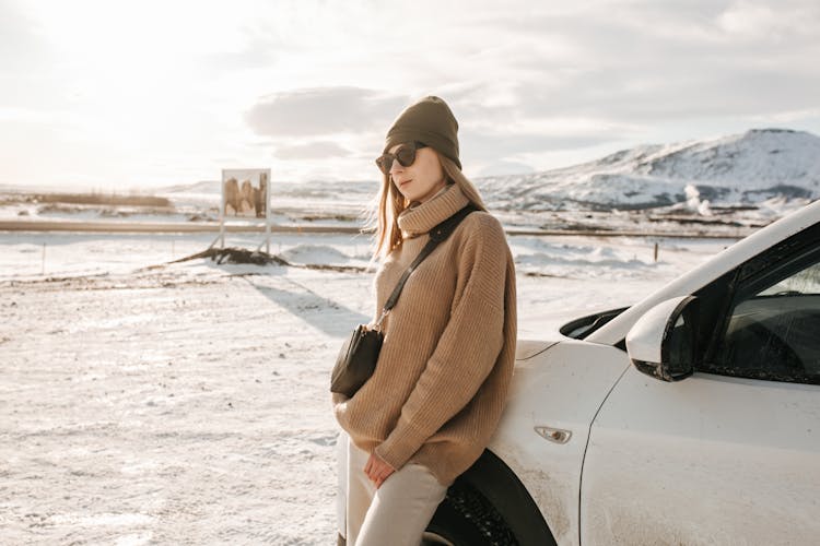 A Stylish Woman Leaning On A Car