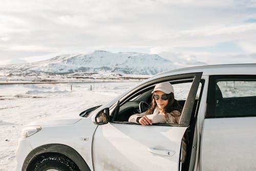 Woman in Car in Mountains in Winter