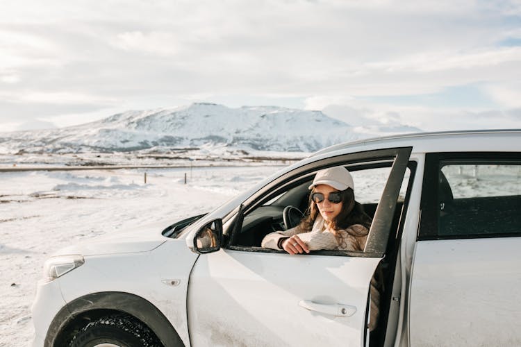 Woman In Car In Mountains In Winter